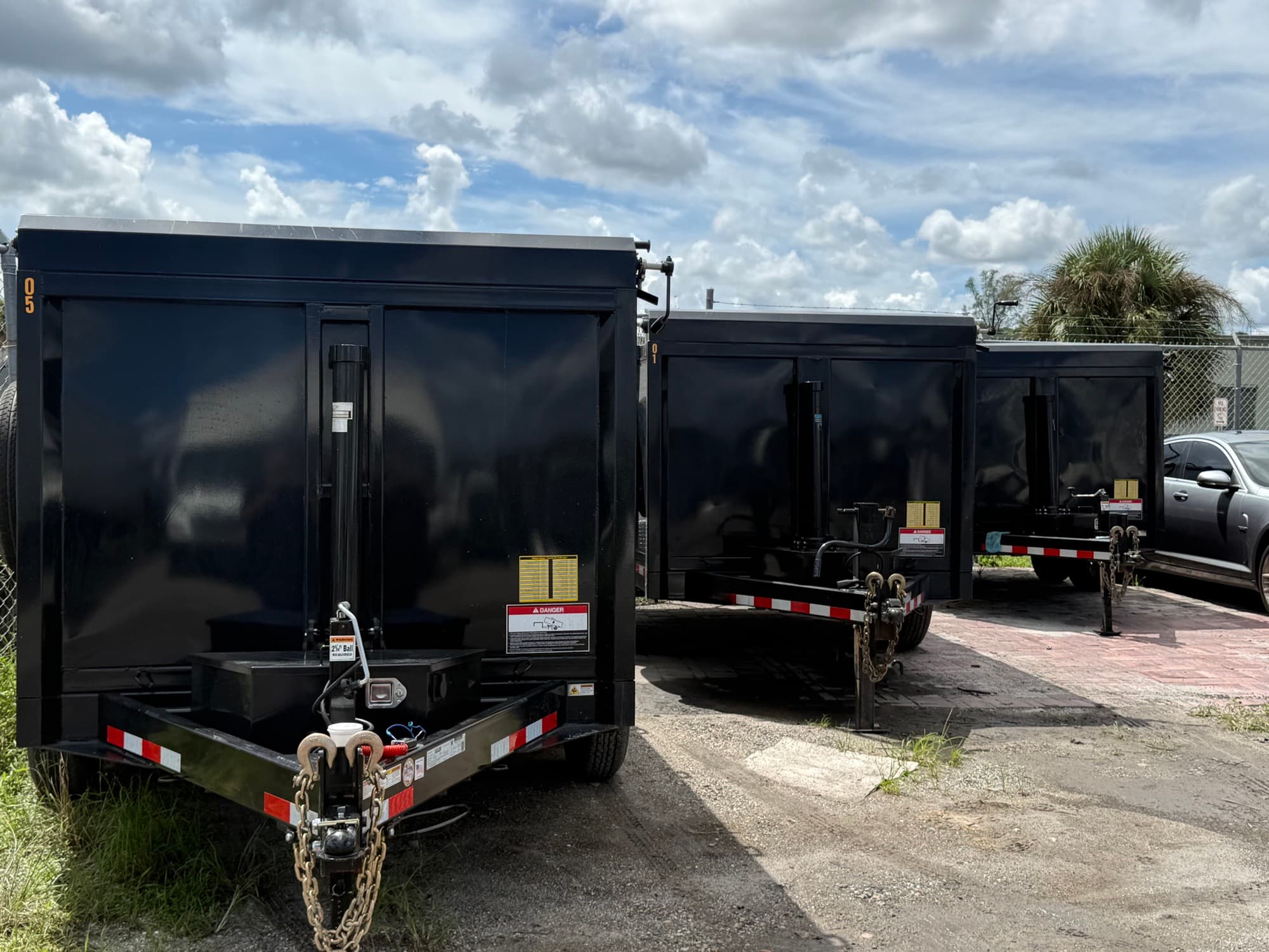 Three black dump trailers parked at the Safe USA Transport yard